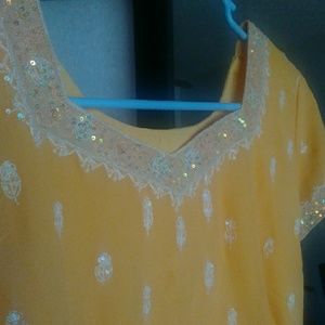 Yellow salwar kameez.